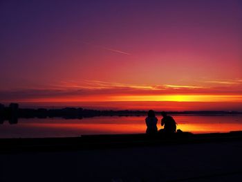 Silhouette of people at sunset