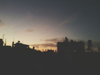 Silhouette city against sky during sunset