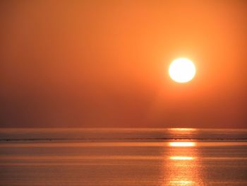 Scenic view of sea against orange sky