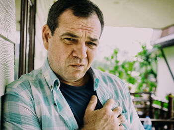 Portrait of mature man suffering from chest pain