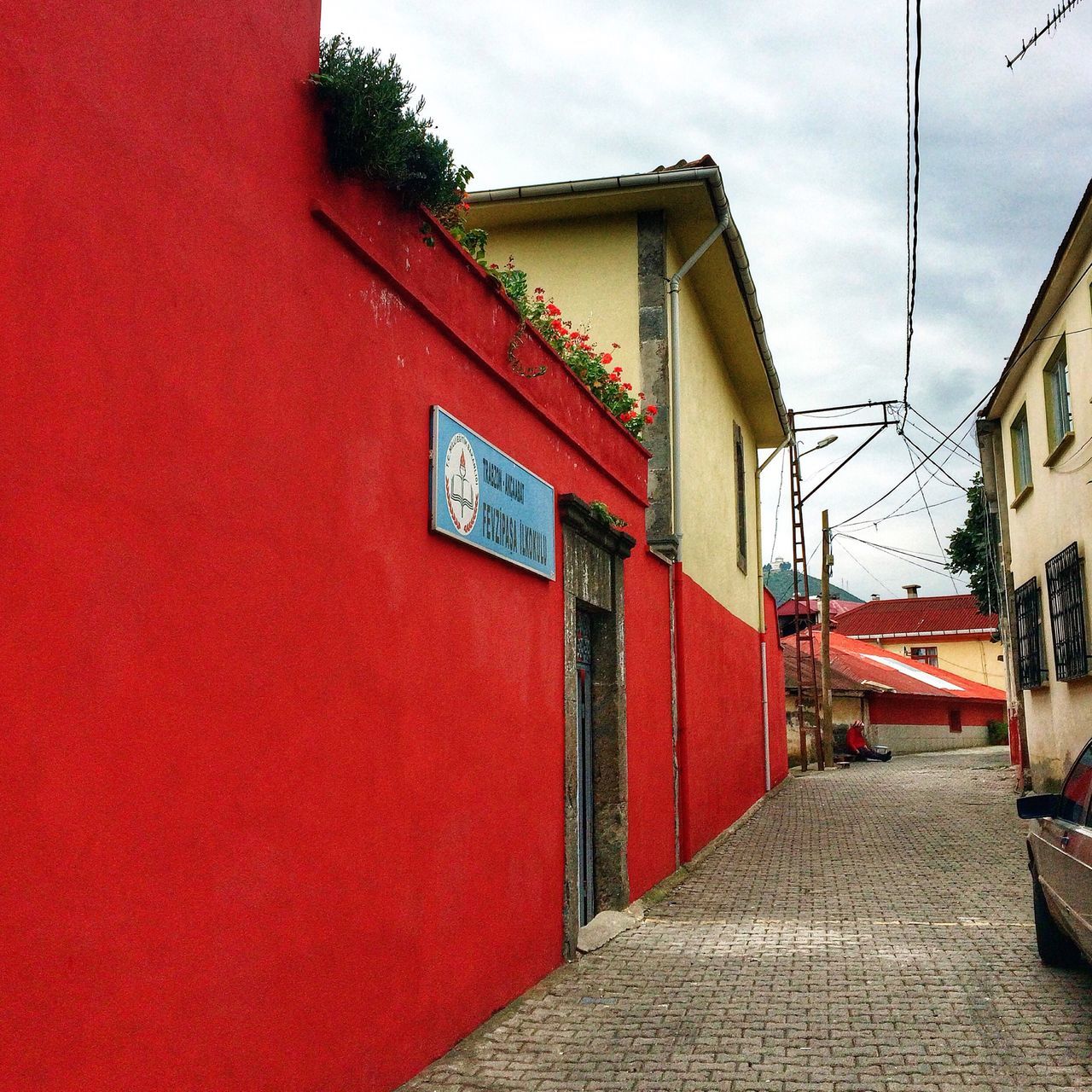 architecture, building exterior, built structure, red, the way forward, house, residential structure, street, residential building, sky, cobblestone, building, narrow, town, city, outdoors, day, no people, wall - building feature, road