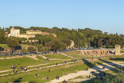 People on landscape against clear sky in circo massimo in rome