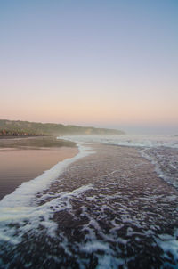 Scenic view of sea against clear sky during sunset