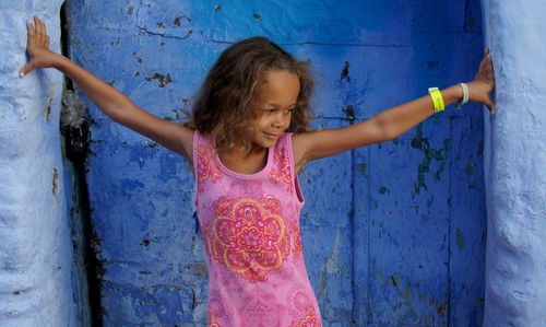 Portrait of girl with arms raised