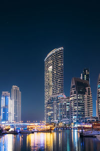 Illuminated buildings in city at night