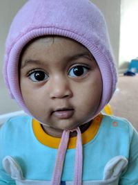 Close-up portrait of cute baby girl at home