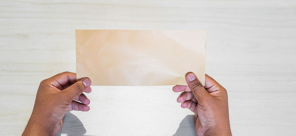 Low section of person holding paper with text