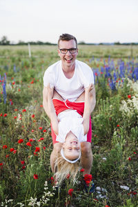 Portrait of smiling young woman on field