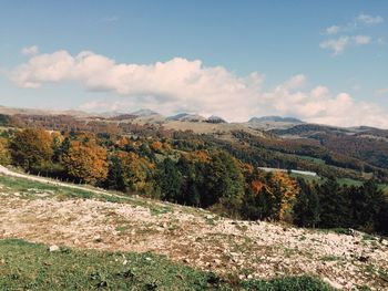 Scenic view of mountains against cloudy sky