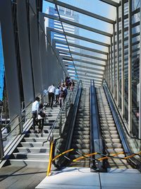 People walking on staircase in city