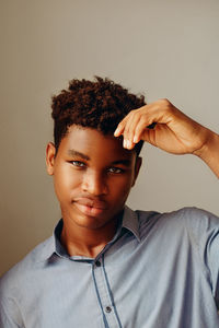 Portrait of man wearing hat against gray background