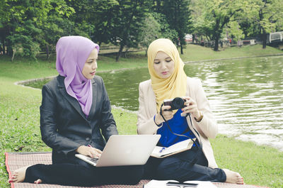 Young woman using mobile phone in park