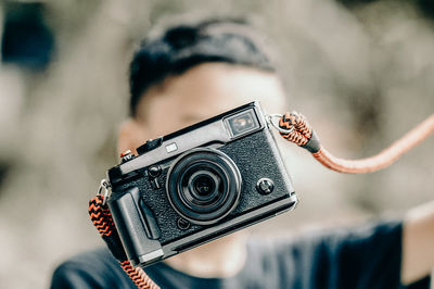 Close-up of boy with camera