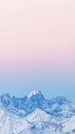 Scenic view of snowcapped mountains against clear sky