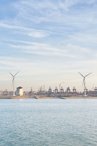 Commercial dock by sea against sky