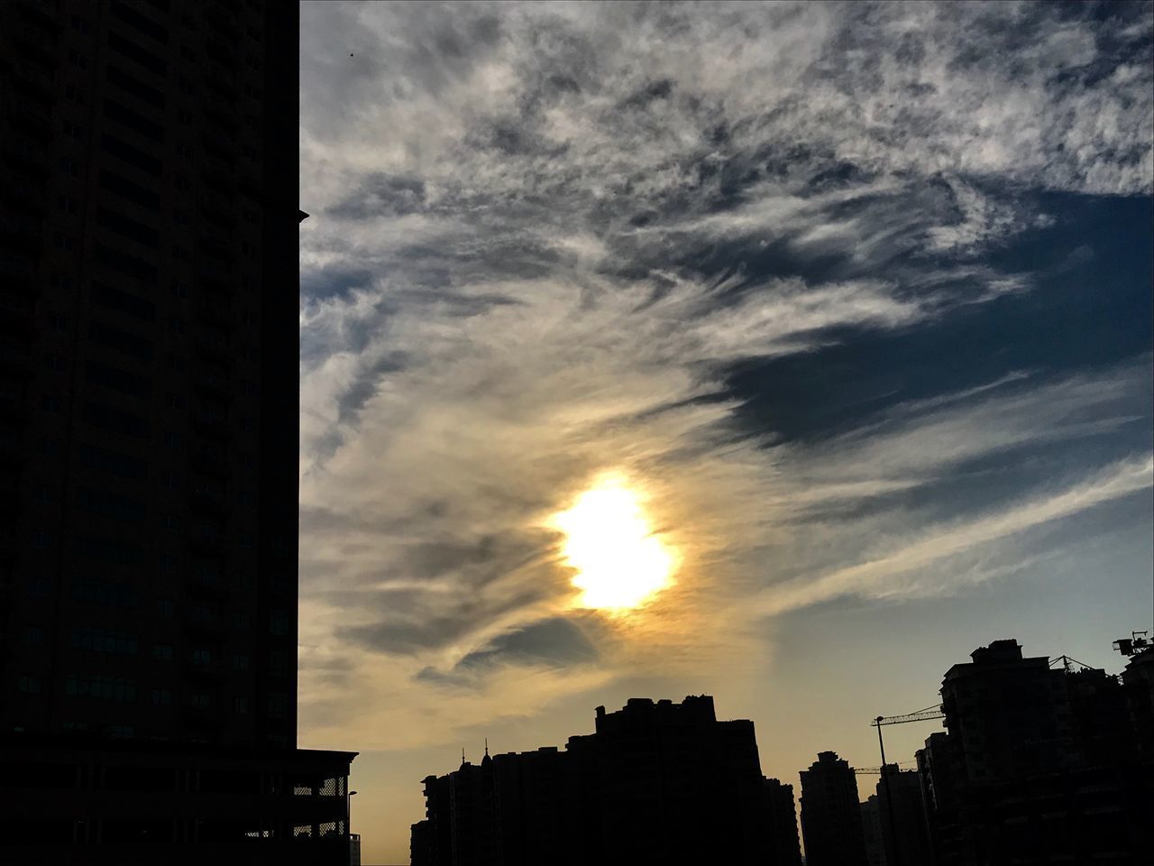 LOW ANGLE VIEW OF SILHOUETTE BUILDINGS AGAINST SKY