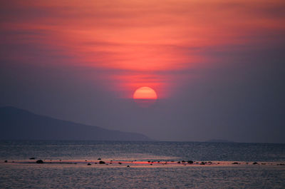 Scenic view of beach against sky during sunset