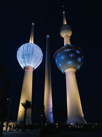 Low angle view of illuminated buildings against sky at night
