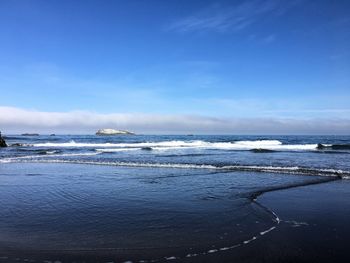 Scenic view of sea against blue sky