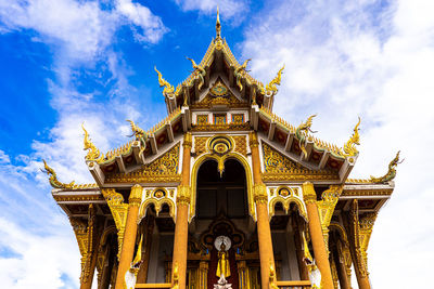 Low angle view of temple building against cloudy sky