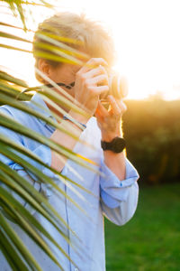 Young photographer taking pictures with a camera