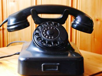 Close-up of vintage telephone on table