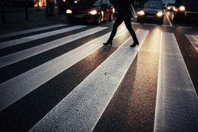 Low section of person crossing road