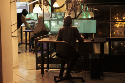 Rear view of woman sitting in cafe