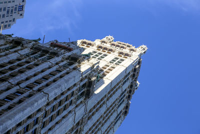 Low angle view of building against clear blue sky