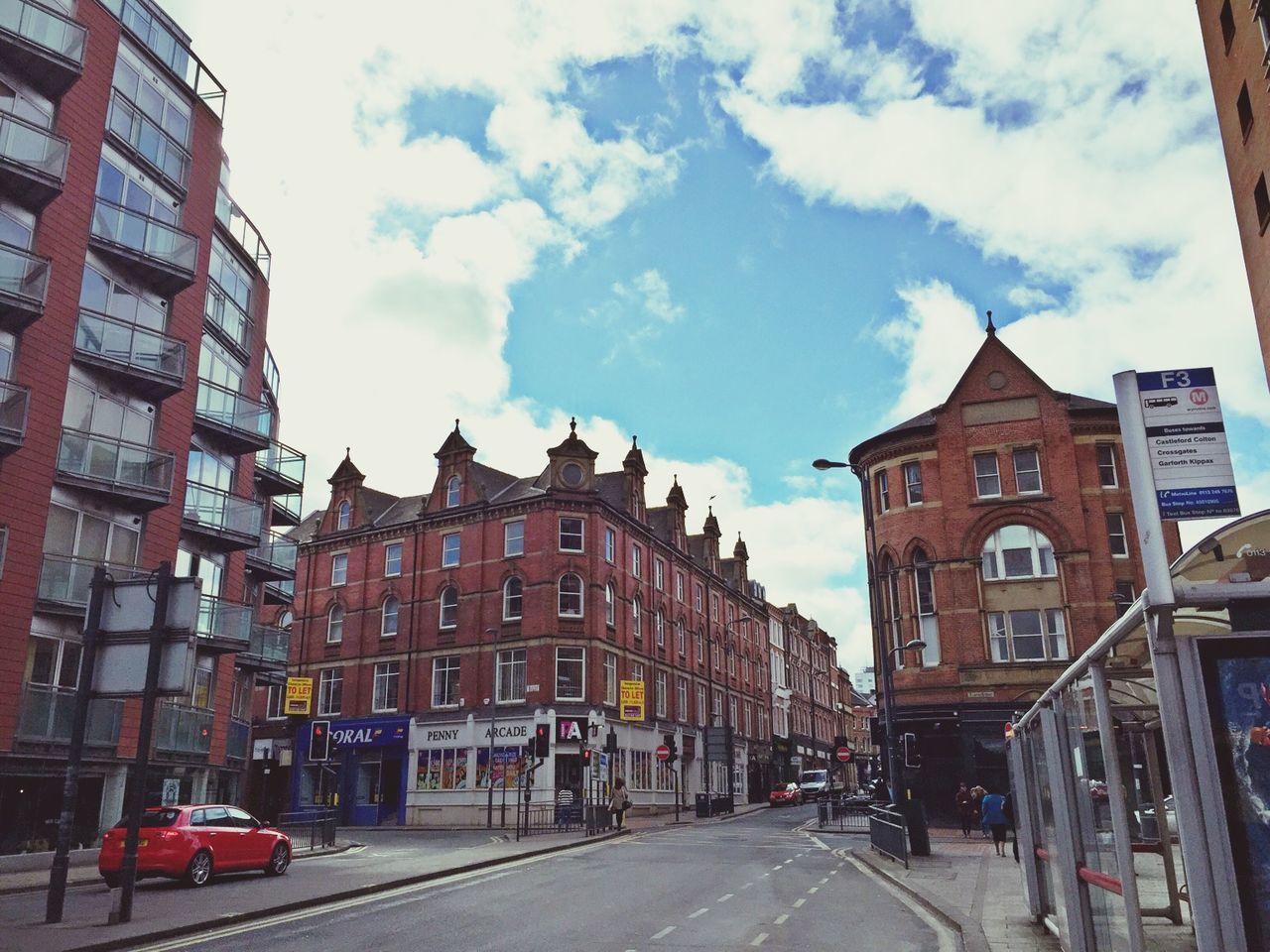 architecture, building exterior, built structure, transportation, street, land vehicle, car, city, sky, road, the way forward, building, mode of transport, residential building, residential structure, city life, incidental people, diminishing perspective, day, outdoors