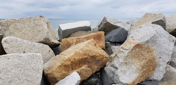Panoramic view of rocks on beach against sky