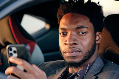 Portrait of young man using smart phone