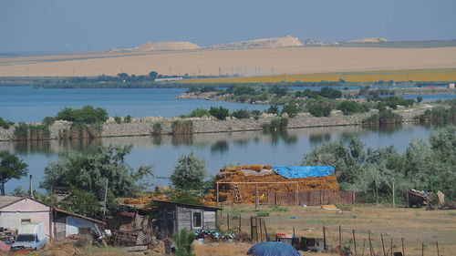 High angle view of lake by buildings against sky