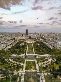 High angle view of city buildings against cloudy sky