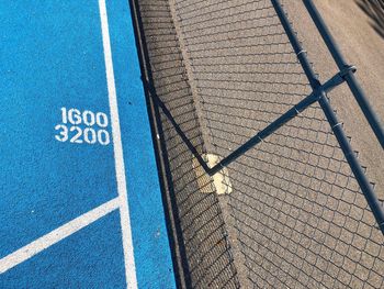 High angle view of text by fence