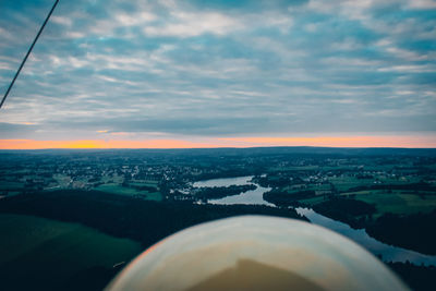 Aerial view of city and buildings against sky during sunset