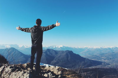 Low angle view of man standing on mountain