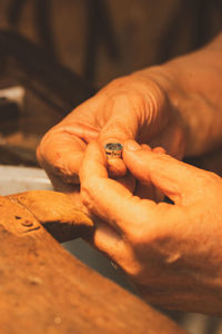 Cropped hand of person holding coin