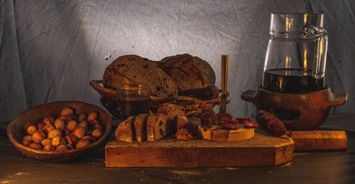 Various village groceries on a table with a jug of wine