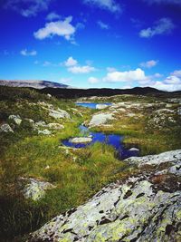 Scenic view of landscape against cloudy sky