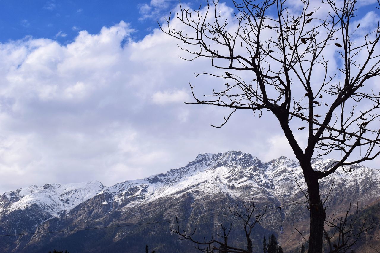 mountain, sky, cloud - sky, scenics - nature, cold temperature, beauty in nature, winter, tranquil scene, snow, tree, tranquility, bare tree, plant, nature, mountain range, snowcapped mountain, non-urban scene, no people, day, outdoors, mountain peak