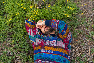 Moroccan man laying on the ground with his hand over his face