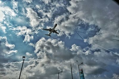 Low angle view of helicopter flying in sky