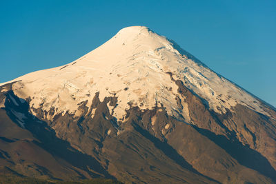 Scenic view of snowcapped mountains against clear sky