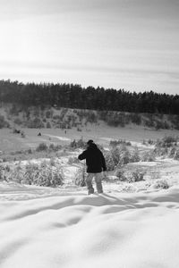 Rear view of man on snow covered land