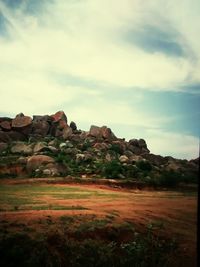 Scenic view of landscape against cloudy sky