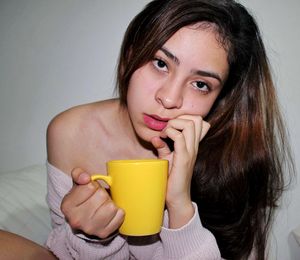 Portrait of a young woman drinking drink