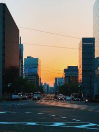 View of city street and buildings against clear sky