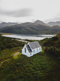 Scenic view of house on landscape against sky