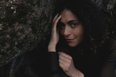 Portrait of beautiful woman with tree trunk